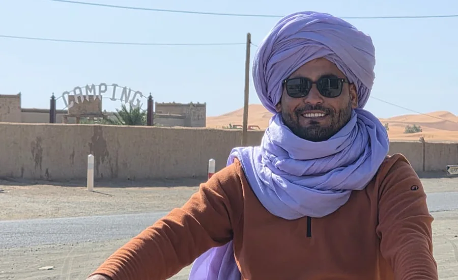 Mohamed with a KTM motorcycle in Merzouga