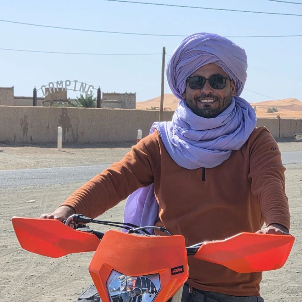 Mohamed on a KTM motorcycle in Merzouga