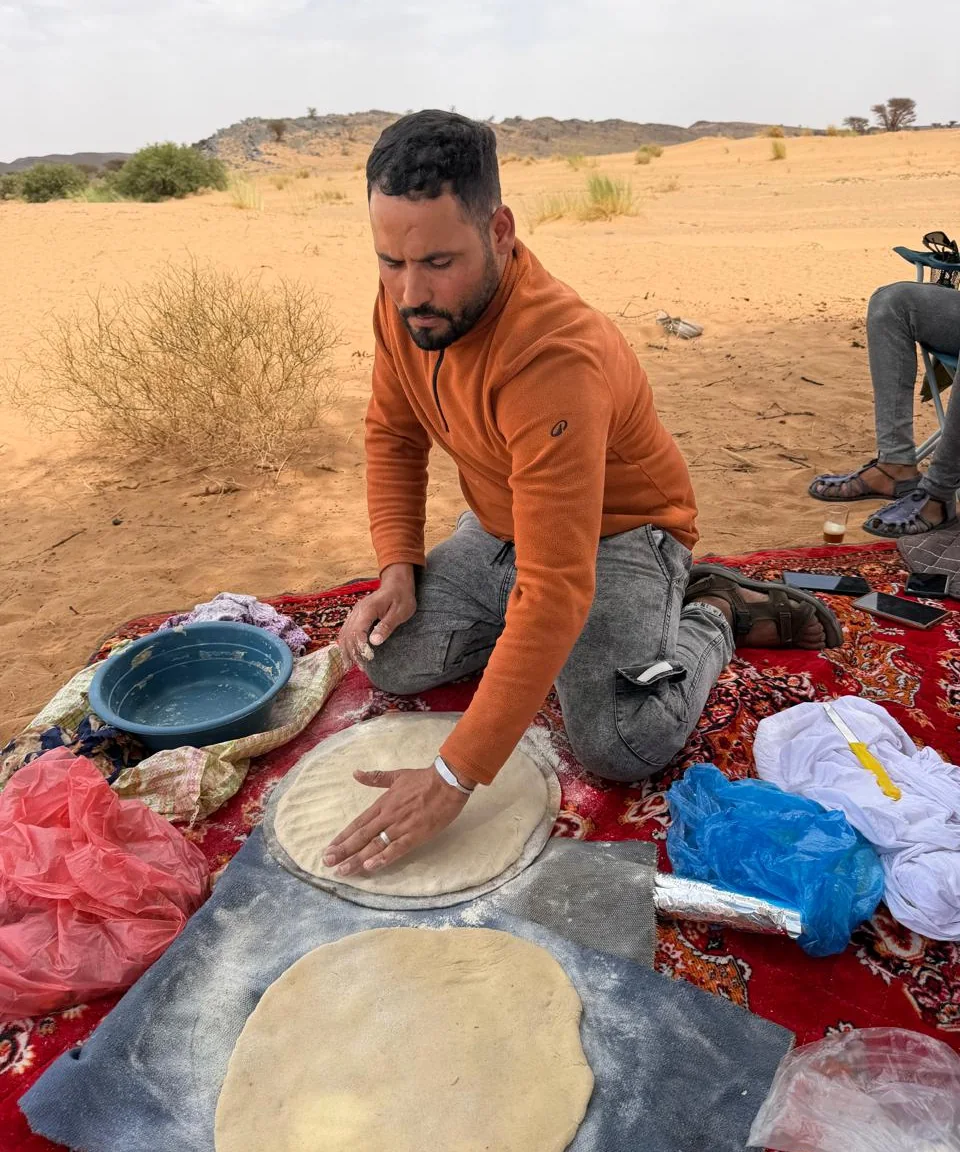 Preparing Madfouna dough during a cooking experience in Merzouga